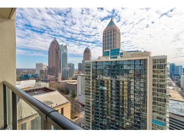 Expansive city views from a high-rise balcony, capturing the Atlanta skyline and bright, partly cloudy skies at 1280 W Peachtree St Nw # 3208, Atlanta, GA 30309