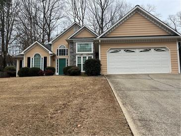 Charming single-Gathering home boasts a two-car garage, manicured landscaping, and a welcoming entrance at 6272 Cheatham Lake Nw Dr, Acworth, GA 30101