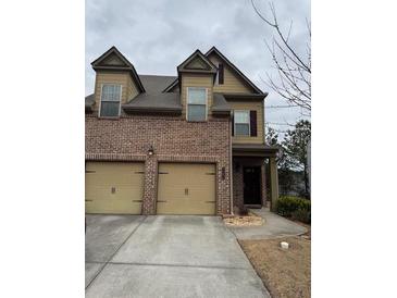 Charming two-story townhome with a brick facade and two-car garage at 1366 Image Xing, Lawrenceville, GA 30045