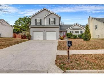 Charming two-story home featuring a two-car garage and well-maintained front yard at 4439 Persian Ct, Snellville, GA 30039