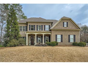 Traditional two-story brick home with a manicured lawn and symmetrical design at 2998 Octavia Cir, Marietta, GA 30062