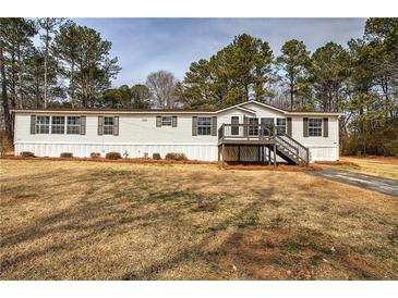 Charming single-story home with a well-maintained lawn and classic architectural details at 62 W Lakeview Dr, Temple, GA 30179
