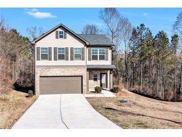 Charming two-story home featuring a brick and vinyl facade, attached garage, and well-manicured lawn at 201 Chert Way, Atlanta, GA 30349