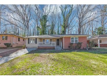 Charming single-story home featuring a brick facade, front porch, and well-maintained lawn, blending classic charm with modern comfort at 2084 Snow Sw Rd, Atlanta, GA 30311