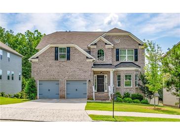 Charming brick two-story home featuring a two-car garage and well-manicured landscaping at 3540 Lindsy Brook, Douglasville, GA 30135
