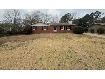 Charming single-story brick home with a well-maintained front yard and traditional design elements at 1789 Riverridge Nw Dr, Conyers, GA 30012