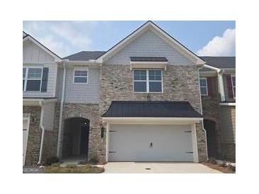 Charming two-story townhome with a brick and gray facade and a two-car garage at 684 Sundial Ln, Mableton, GA 30126