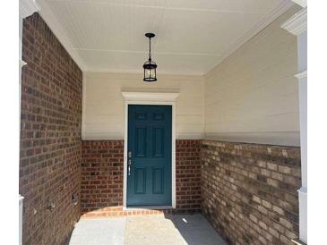 Charming entryway with a craftsman style door and brick accents at 684 Sundial Ln, Mableton, GA 30126