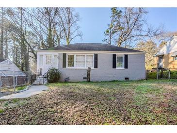 Charming, single-story home with grey brick and well-kept front yard at 1810 Oakmont Nw Dr, Atlanta, GA 30314