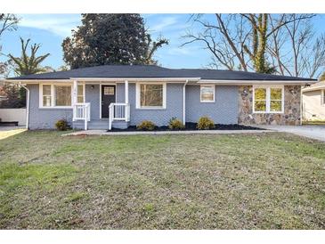 Charming single-story home with stone accents, complemented by a well-maintained lawn and inviting curb appeal at 1961 S Columbia, Decatur, GA 30032