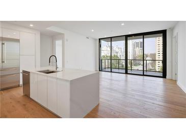 Bright, open kitchen with stainless steel appliances, center island, and large windows at 2425 Peachtree Ne Rd # 903, Atlanta, GA 30305