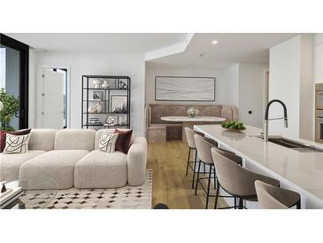 Bright living room featuring modern furniture, an open layout, and beautiful hardwood floors, creating an inviting atmosphere at 2425 Peachtree Ne Rd # 903, Atlanta, GA 30305