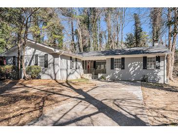 Charming single-story home with brick facade, dark shutters, driveway, and inviting landscaping at 3699 Narron Sw Dr, Atlanta, GA 30331