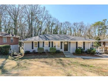 Charming single-story home with a gray exterior, trimmed bushes, and a well-manicured lawn at 1662 Flintwood Se Dr, Atlanta, GA 30316
