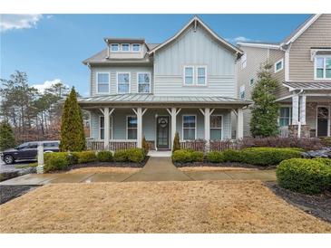Charming two-story home with light blue siding, inviting front porch, and well-manicured landscaping at 33 Hardpan Aly, Marietta, GA 30066