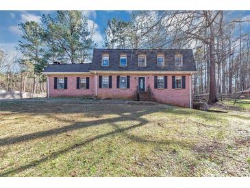 Charming brick home with classic black shutters and lush green lawn, perfect for Gathering living at 4332 N Hickory Ln, Douglasville, GA 30134