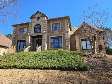 Stately brick home with manicured front lawn and detailed stonework at 4520 Mossey Dr, Lithonia, GA 30038