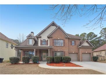 Stunning brick home with well-manicured landscaping and a two-car garage at 2143 Great Shoals Cir, Lawrenceville, GA 30045