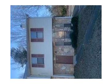 Two-story house with vinyl siding, stone accents, and mulled windows at 3626 Hopkins Ct, Powder Springs, GA 30127