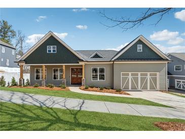 Charming single-Gathering home featuring a craftsman style and beautifully manicured front yard at 9089 Hanover St, Lithia Springs, GA 30122