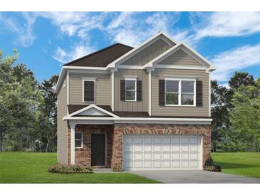 Charming two-story home features a brick facade, gray siding, and a two-car garage at 1265 Elowen Dr, Austell, GA 30168