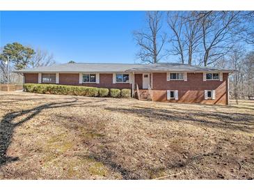 Charming brick home featuring a well-maintained front yard and a classic, inviting facade at 346 Mays Rd, Stockbridge, GA 30281