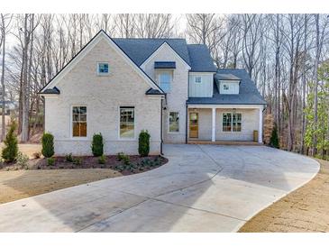 Charming brick home featuring a well-manicured front yard and a concrete driveway at 4356 Hamilton Mill Rd, Buford, GA 30518