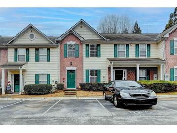 Attractive townhome exterior features a brick facade, neutral siding, and green shutters, creating a welcoming curb appeal at 3154 Panthers Trce, Decatur, GA 30034
