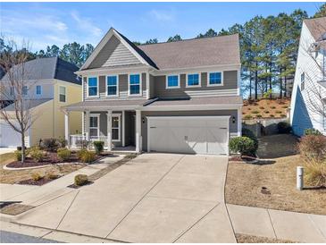 Charming two-story home with a two-car garage and meticulously landscaped front yard at 232 Providence Ln, Canton, GA 30114