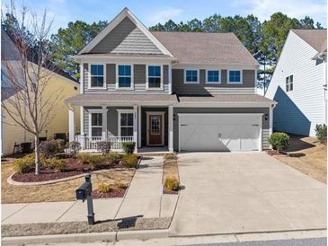 Charming two-story home with a well-manicured front yard and a two-car garage at 232 Providence Ln, Canton, GA 30114