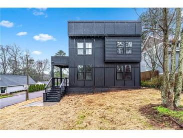 Modern two-story home with unique black exterior, complemented by a well-manicured lawn at 3139 Alston Dr, Decatur, GA 30032