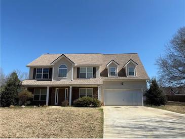 Charming two-story home with a well-manicured lawn, attached garage and inviting front porch in a lovely neighborhood at 1073 Crown Landing Pkwy, Mcdonough, GA 30252