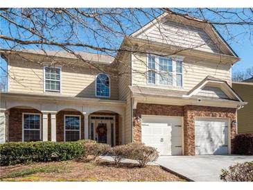 Charming two-story home featuring a stone veneer garage and inviting front porch at 599 Jefferson Chase St, Atlanta, GA 30354