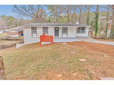 Exterior view of house showcasing newly painted brick, updated landscaping, and modern design at 125 Glenrose Sw Cir, Atlanta, GA 30354