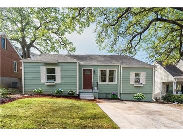 Charming single-story home with a well-manicured lawn, flower boxes and mature trees at 306 Nelms Ne Ave, Atlanta, GA 30307