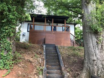 Charming home featuring a covered porch and an inviting entrance with a staircase at 1140 Smith Sw St, Atlanta, GA 30310