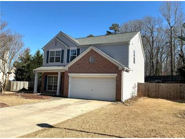 Charming two-story home features a brick-accented facade, attached garage, and inviting front yard at 2979 Belfaire Crest Ct, Dacula, GA 30019