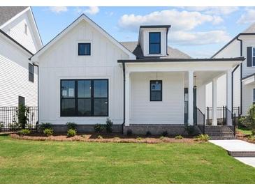 Charming, craftsman style home with white wood facade, black trim, and an inviting front porch at 528 Pearl St, Cumming, GA 30519