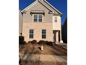 Charming two-story home featuring a brick facade, well-maintained landscaping, and a welcoming entrance at 1852 Laurel Green Way, East Point, GA 30344