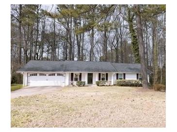 Charming single-story home with an attached two-car garage and a well-maintained front yard at 566 Sugar Valley Lane, Conyers, GA 30094