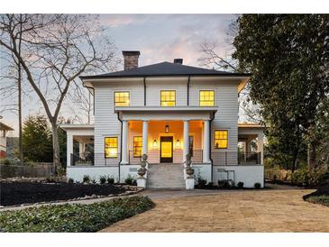 Stately two-story home featuring a columned front porch, black framed windows, and landscaped yard at 818 Springdale Ne Rd, Atlanta, GA 30306