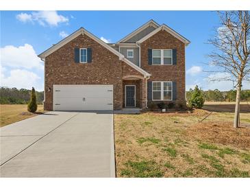 Charming brick two-story home with a well-maintained front yard and attached two-car garage at 1246 Allspice Way, Lawrenceville, GA 30045