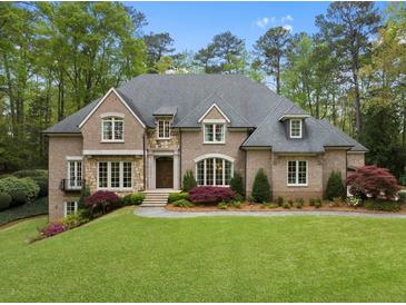 Stunning brick home with a meticulously manicured lawn and elegant landscaping at 581 Fairfield Nw Rd, Atlanta, GA 30327