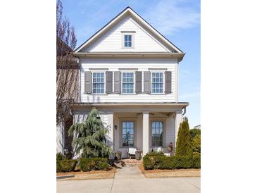 Charming two-story home with a welcoming front porch and manicured landscaping at 108 Brighton Blvd, Woodstock, GA 30188