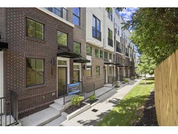 Charming brick townhomes with well-maintained landscaping and inviting entranceways at 201 New St # 2301, Decatur, GA 30030