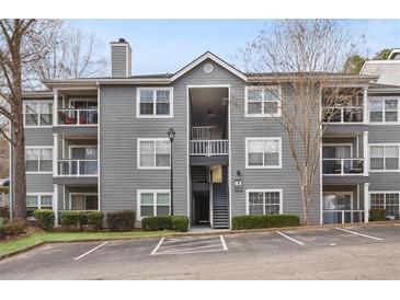 Attractive three-story condo building with balconies, gray siding and well maintained landscape at 3103 Santa Fe Pkwy, Atlanta, GA 30350