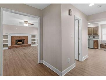 Inviting living room features a cozy brick fireplace flanked by custom built-in shelving at 105 Lakeview Ln, Stockbridge, GA 30281