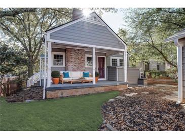 Charming home featuring a welcoming front porch with cozy seating and a well-manicured lawn at 371 Blake Se Ave, Atlanta, GA 30316