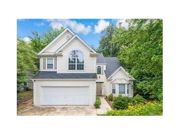 Charming two-story home with well-maintained landscaping and inviting curb appeal at 113 Weatherstone Dr, Woodstock, GA 30188