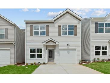 Charming two-story home with light grey siding, brown shutters, and a one car garage at 170 Chandler Trace, Covington, GA 30016